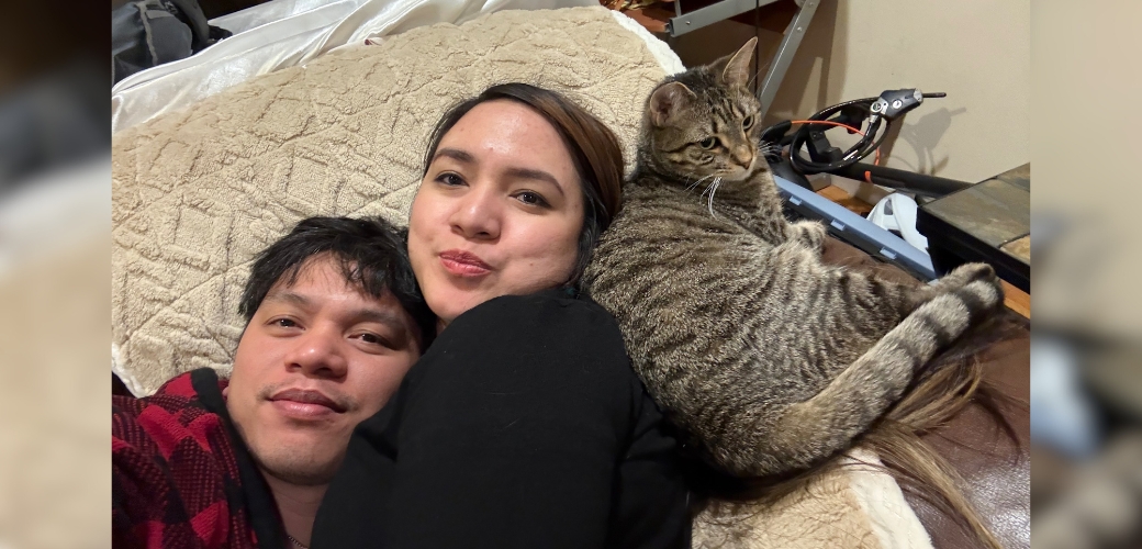adopters laying with their new cat
