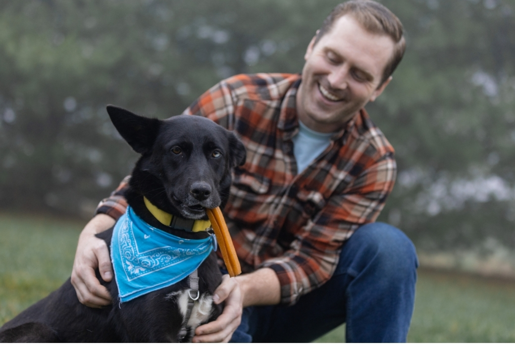 dog and his adopter playing outside