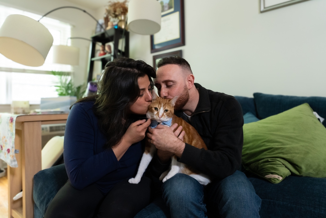 adopters kissing their cat