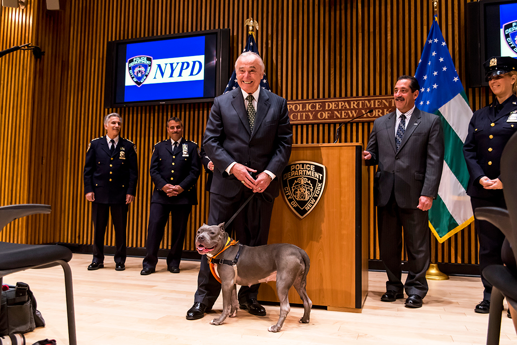 Bratton and Zaza standing next to the podium