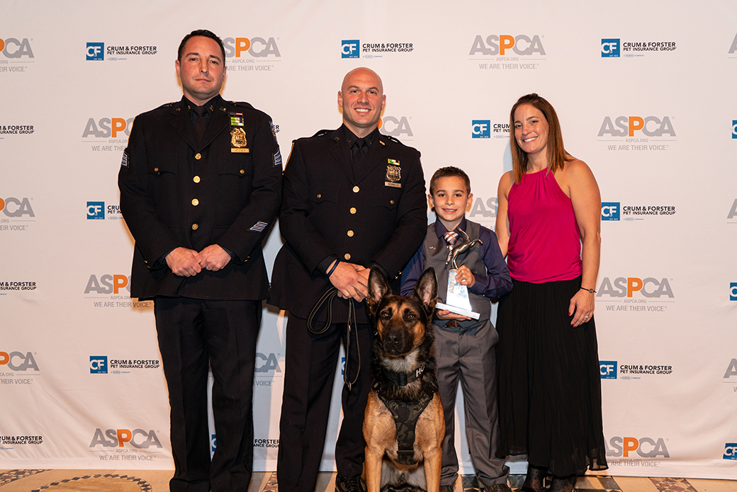 Brady Snakovsky with two police officers and a police dog