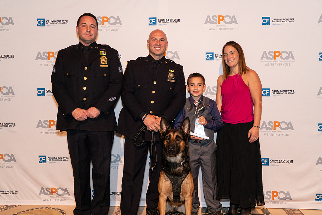 Brady with his mother, two police officers, and a police dog