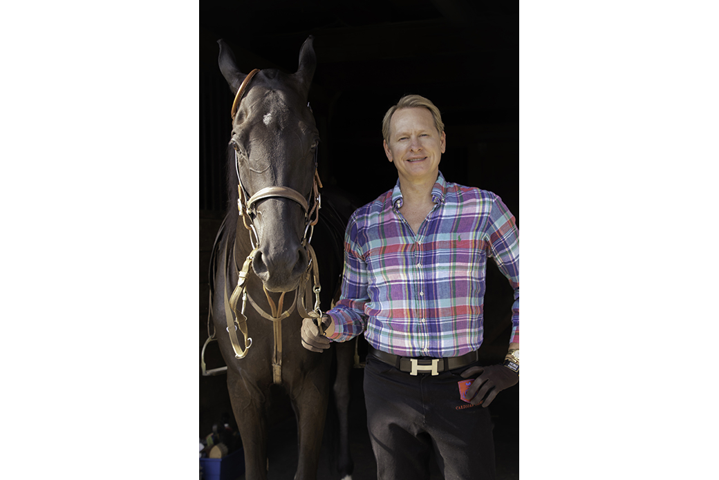 Carson Kressley standing next to a brown horse