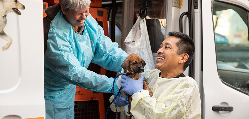 ASPCA staff carrying a puppy