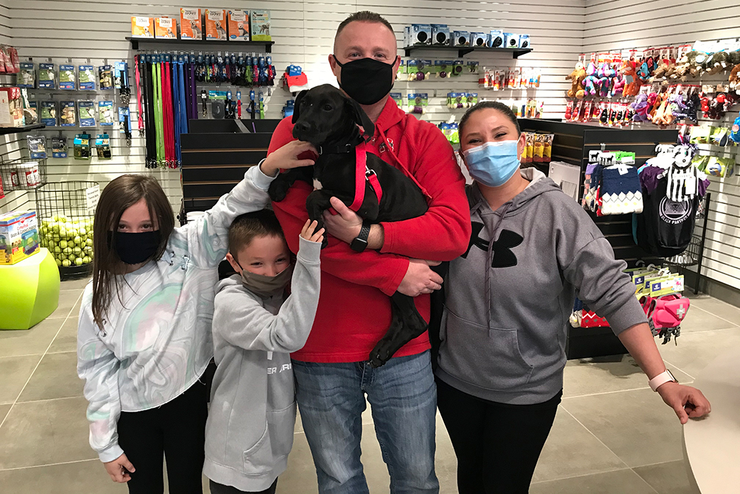 A family with a newly adopted dog