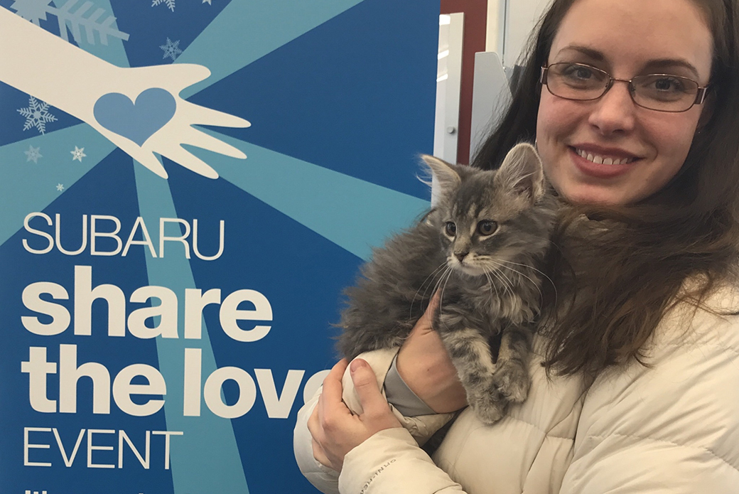 a woman with her cat at a subaru share the love event