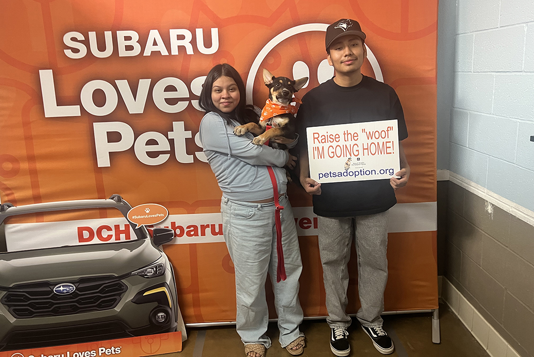 A family photo with newly adopted dog Snoopy at a Subaru STL event in Riverside, CA