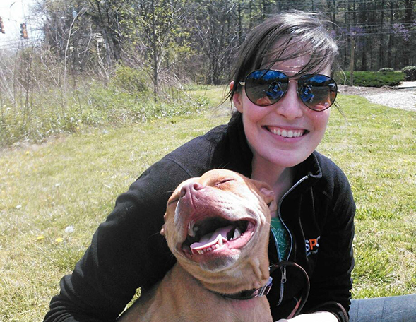 ASPCA responder posing with happy pit bull