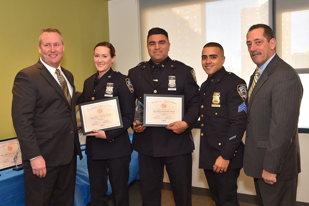 Police Officers Lori Murray and Daniel Pardo with Howard Lawrence and Michael Mugan.