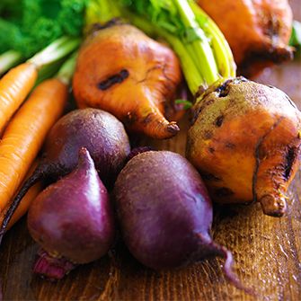 fresh carrots, beets, and leafy greens